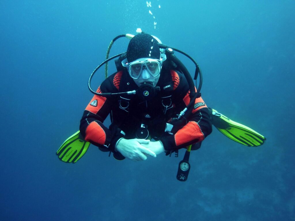 divers scuba divers diving underwater 37530 37530 A diver in a drysuit exploring the ocean depths with full scuba gear.